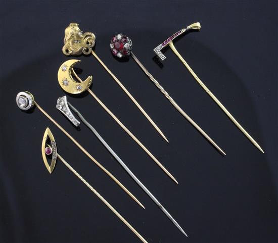 Seven early 20th century assorted gem set stick pins, all approx. 2.5in.